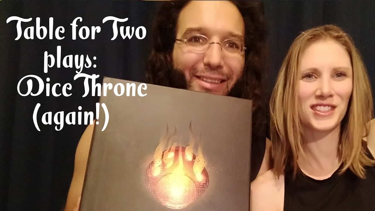 couple posing with dice throne boardgame box