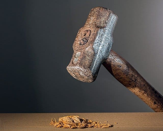 sledge hammer crushing walnut