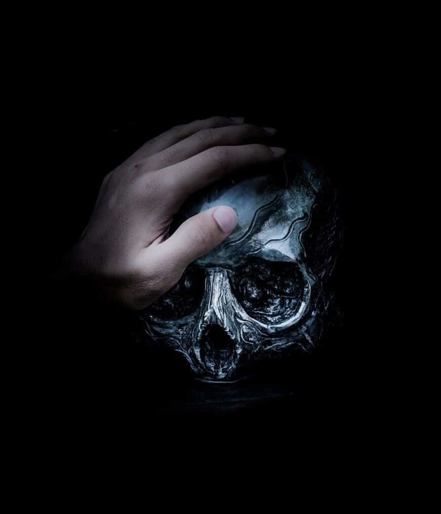 hand petting dark skull