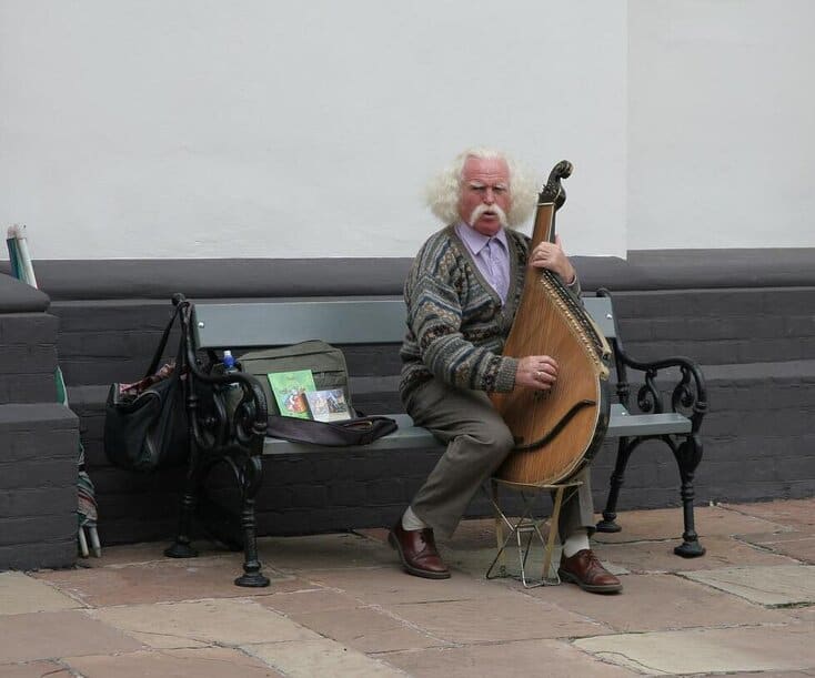 bard playing on bench