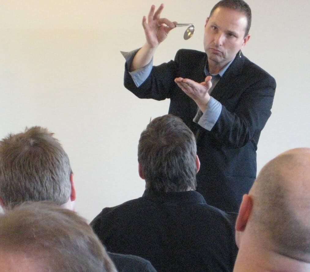 Man demonstrating bending spoon trick